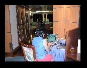 Angie is working hard at the computer in the internet cafe. Pricey but allows you to keep up with business.